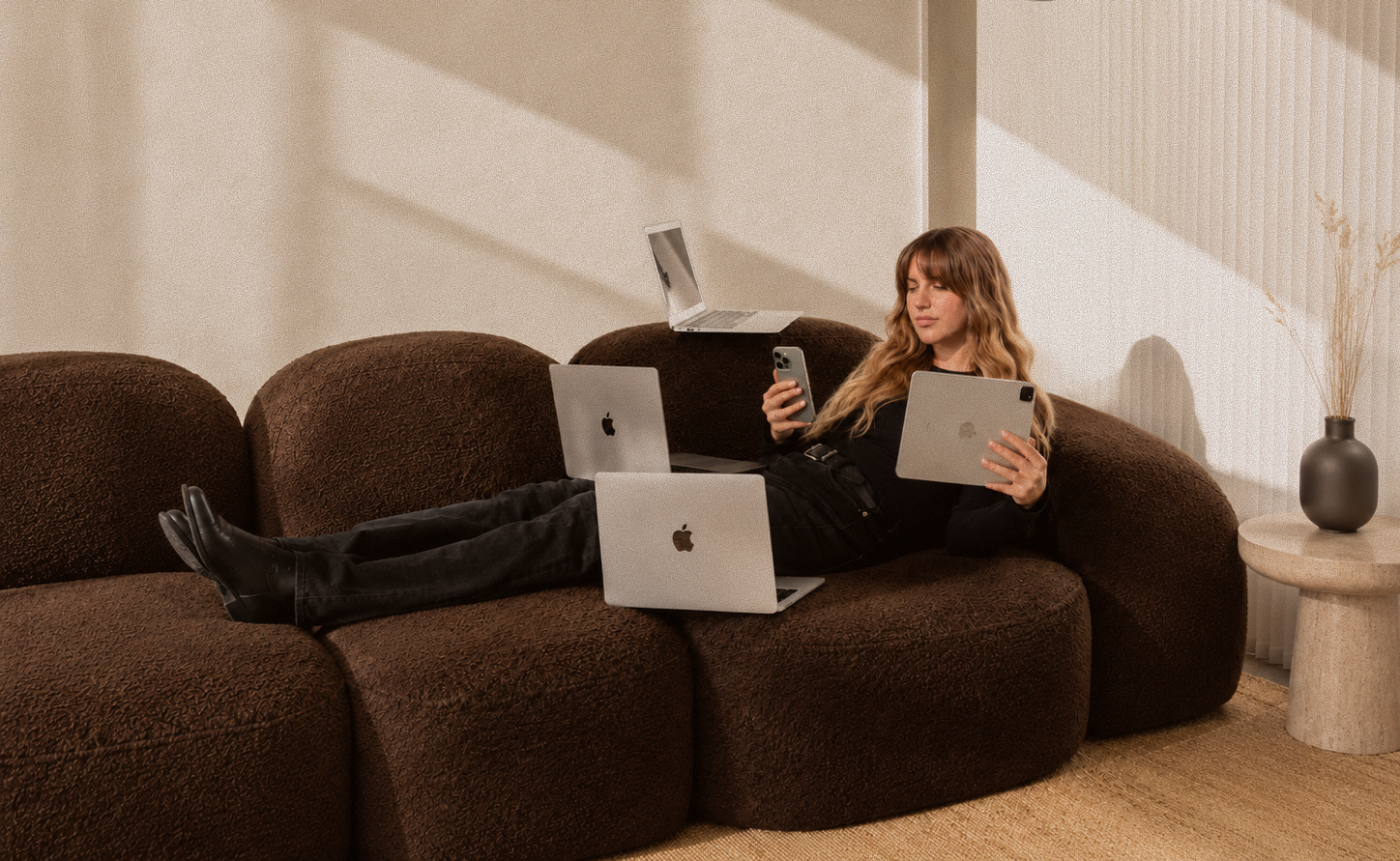 Jessa Black working on couch with multiple devices